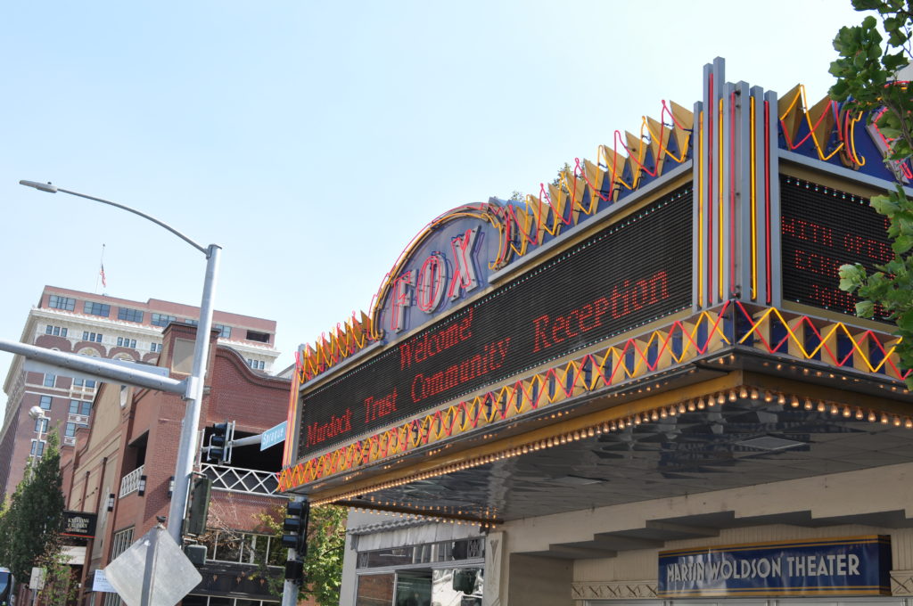 An outdoor shot of the historic Fox Theater, with the sign displaying "Welcome! Murdock Trust Community Reception"