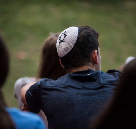 A shot from behind of a young man wearing a kippah.