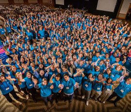 A group photo of nearly four hundred college students wearing blue tshirts at the 2022 MCSR Conference