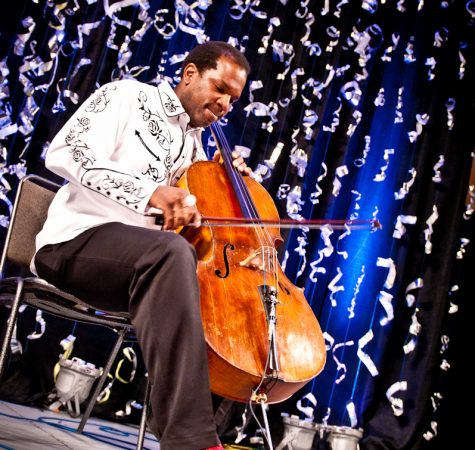 A man playing cello on stage
