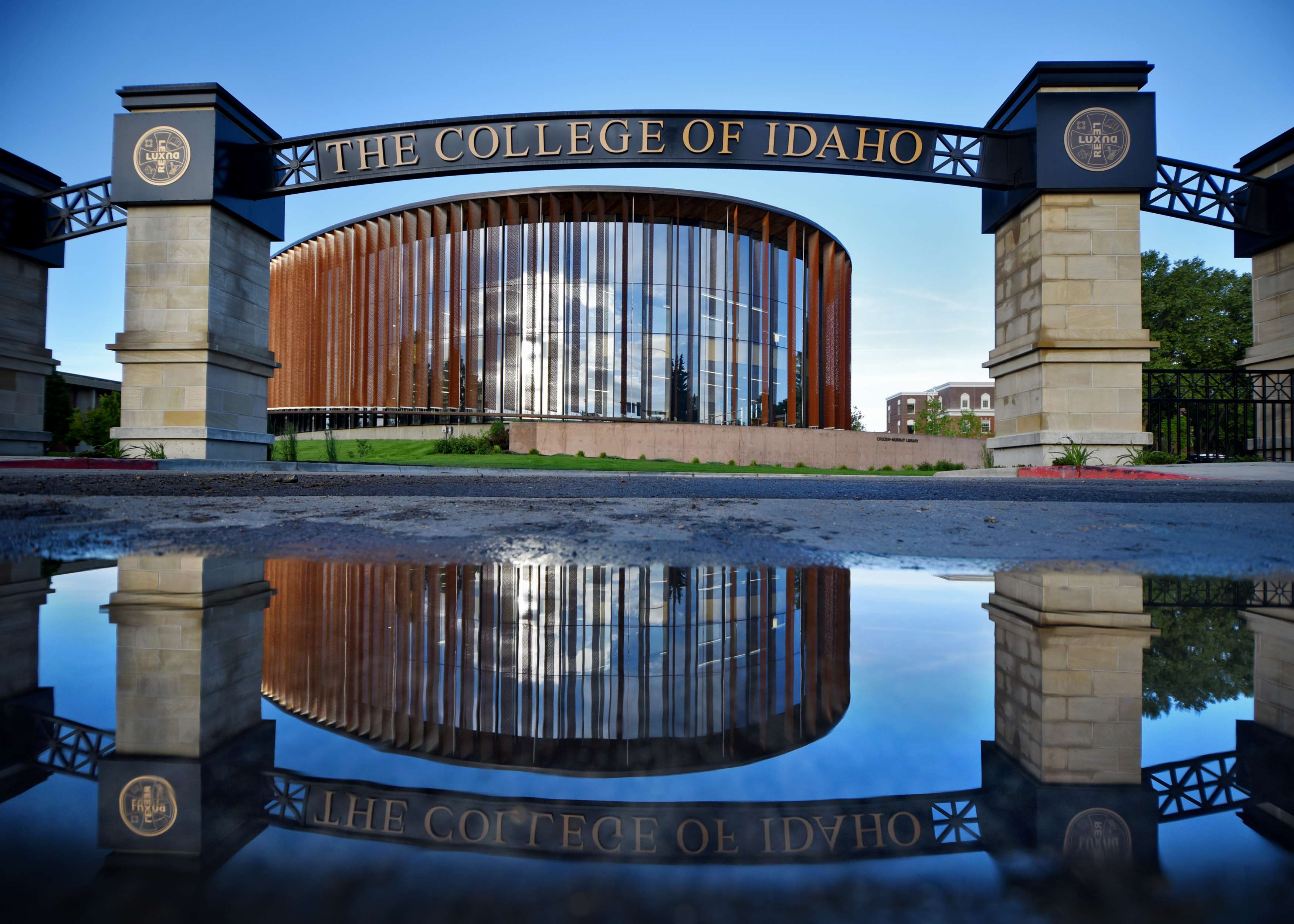 College of Idaho arch and reflection in puddle of water