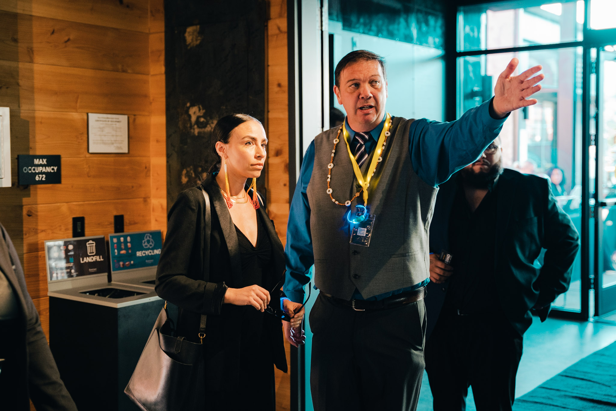 Two people in business attire, one pointing in distance