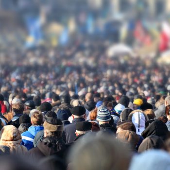 A large crowd of people, many wearing beanies and coats.