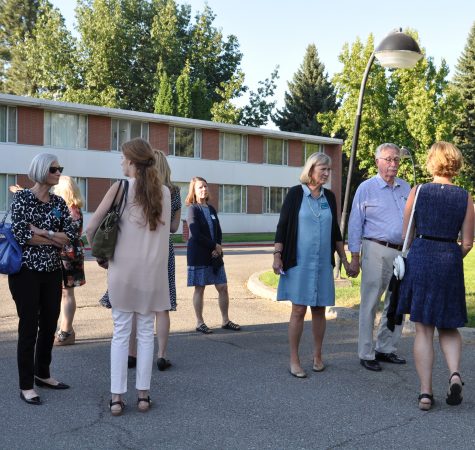 A group of adults stand outside the Immaculate Heart Retreat facility.