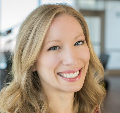 A woman with blonde hair smiling at the camera.