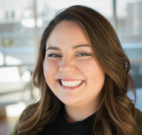 A woman with brown hair smiling at the camera.