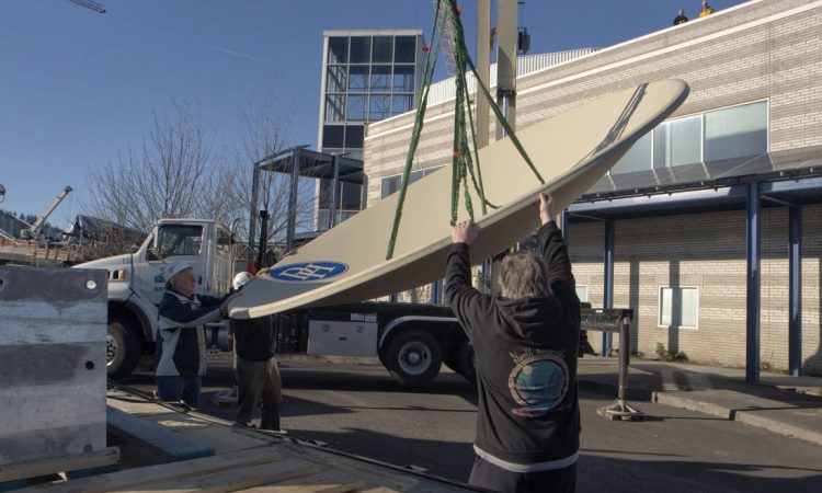 A crew of workers install broadcasting equipment at All Classical Portland.