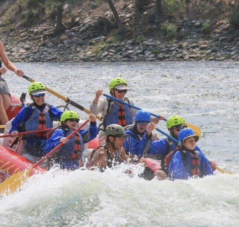 A group of young people raft on a river