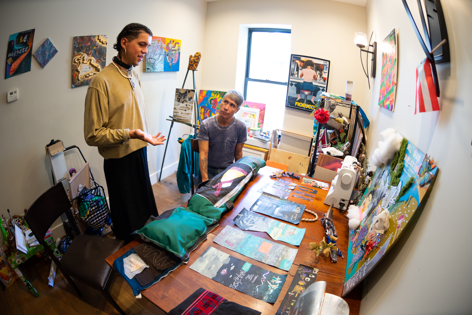 An artist explains something inside his studio.