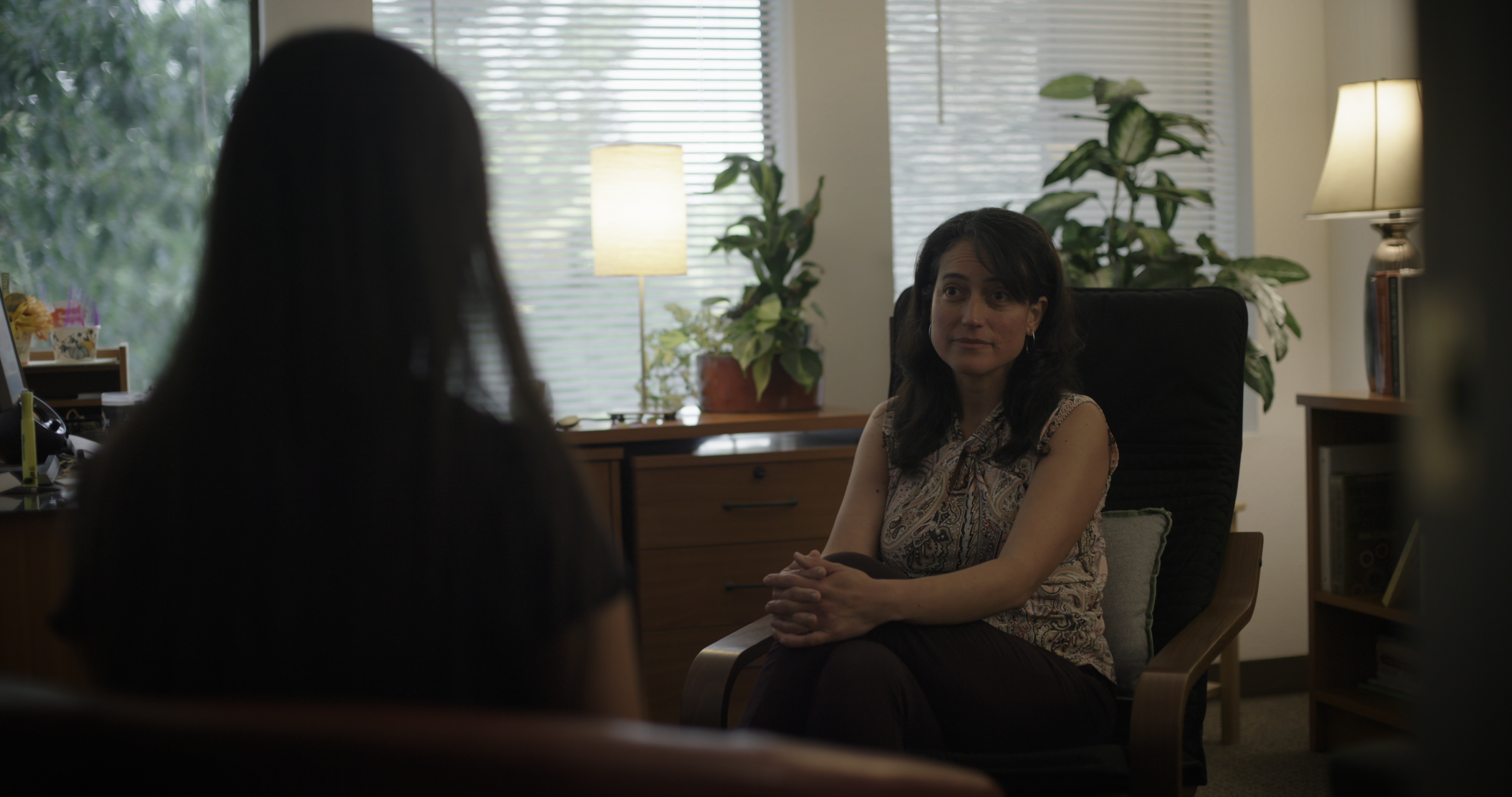 A woman with long brown hair at the Northwest Catholic Counseling Center conducts a session.