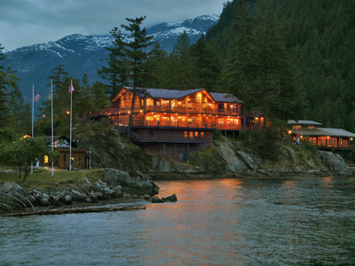 Young Life's Malibu Club cabin located in the Sunshine Coast in Canada, surrounded by water and trees with mountains in the background