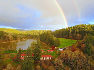 Tilikum Center for Retreats grounds with a rainbow and sunny sky overhead