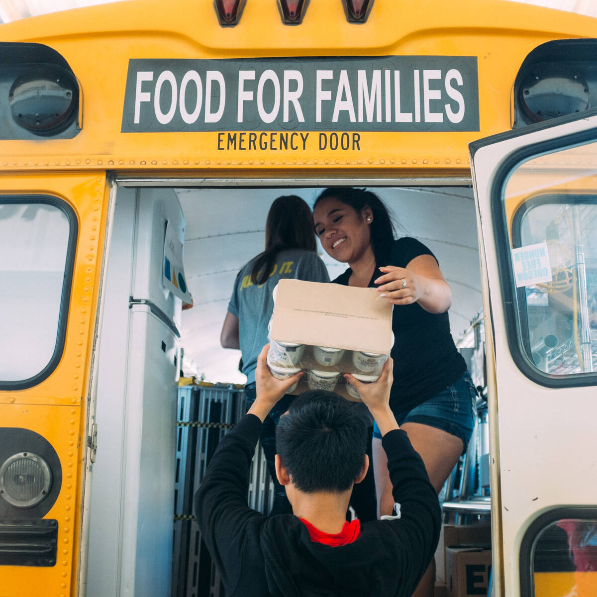 Volunteers helping load food into a bus for Oregon Food Bank