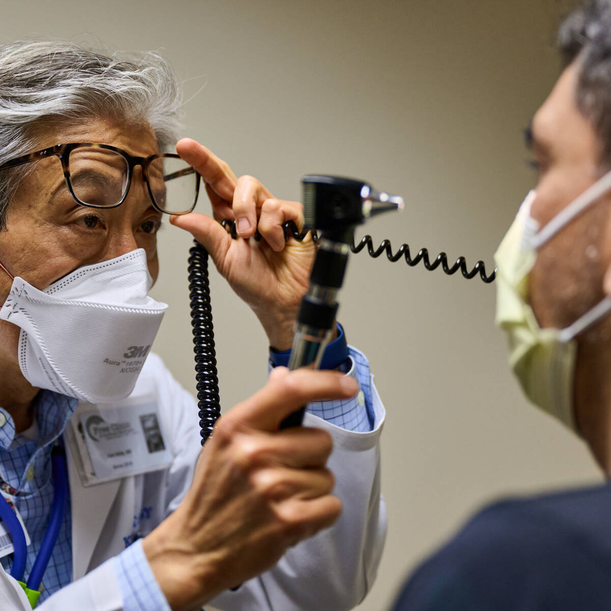 Doctor inspecting a patient at a free health clinic in Washington
