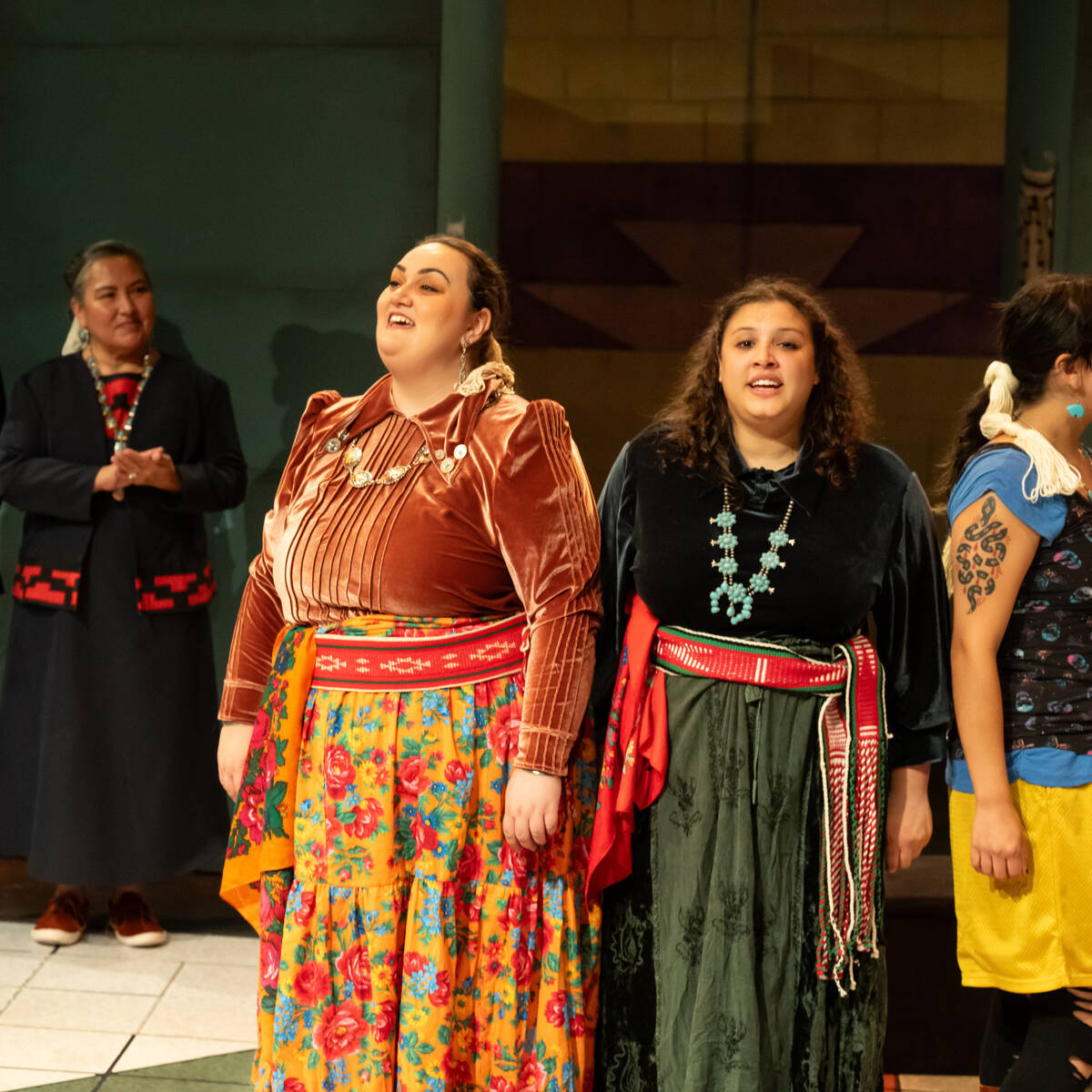 Three people in costume on stage at an Oregon theatre performance