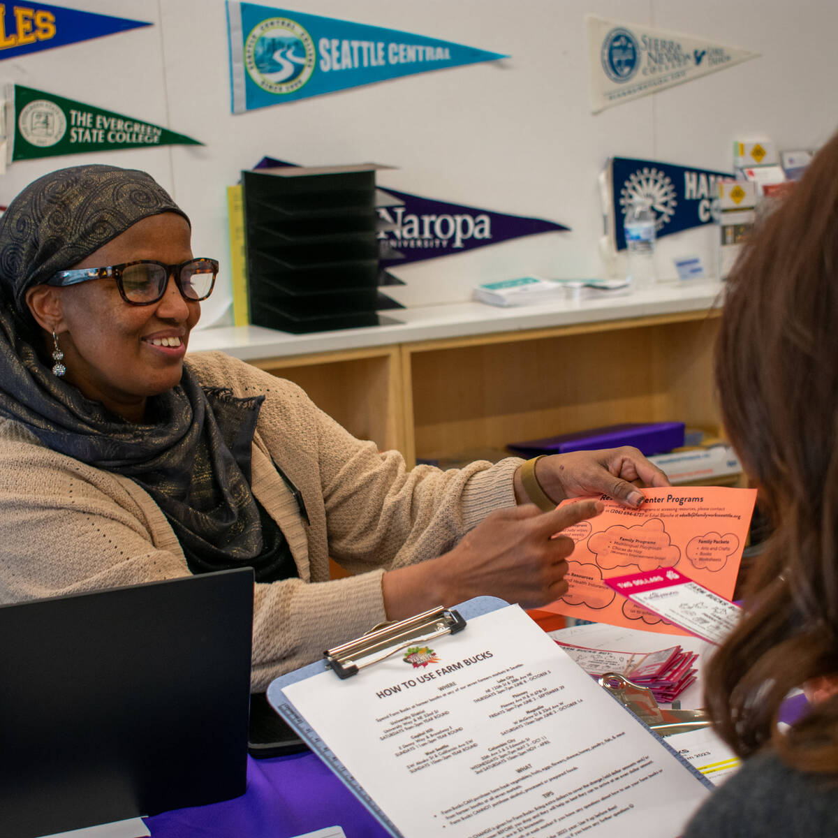 Seattle nonprofit worker sharing some paperwork with a community member