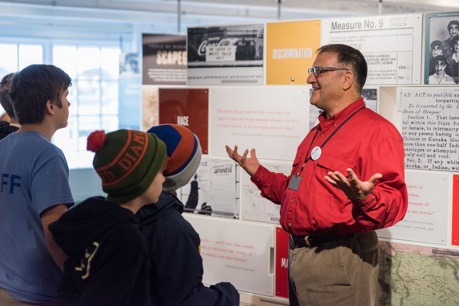 Group of teens and children listening to a guide at the Oregon Jewish Museum and Center for Holocaust Education in Portland