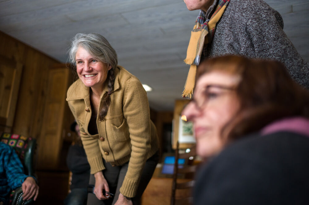 High Desert museum cohort smiling and sitting and standing indoors